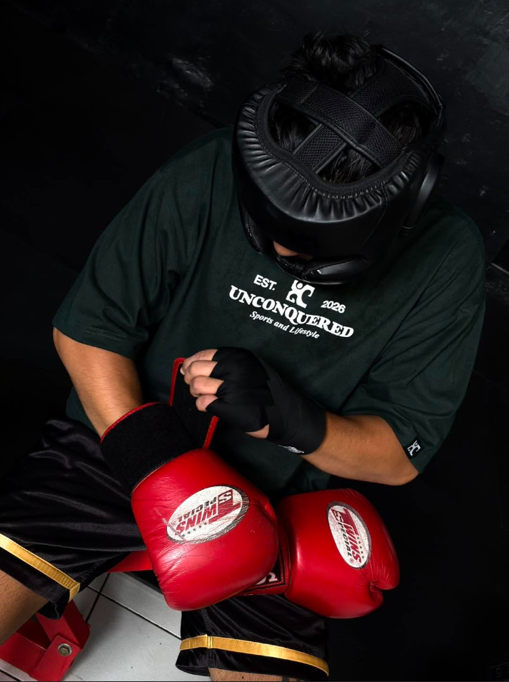 Athlete in Unconquered tee preparing for boxing match