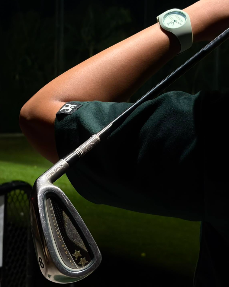 Athlete wearing Unconquered apparel with golf club